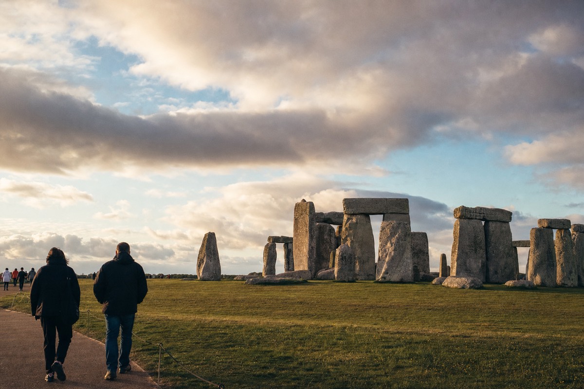 Ancient standing stones rising from a wide, empty grassy plain under a big open sky
