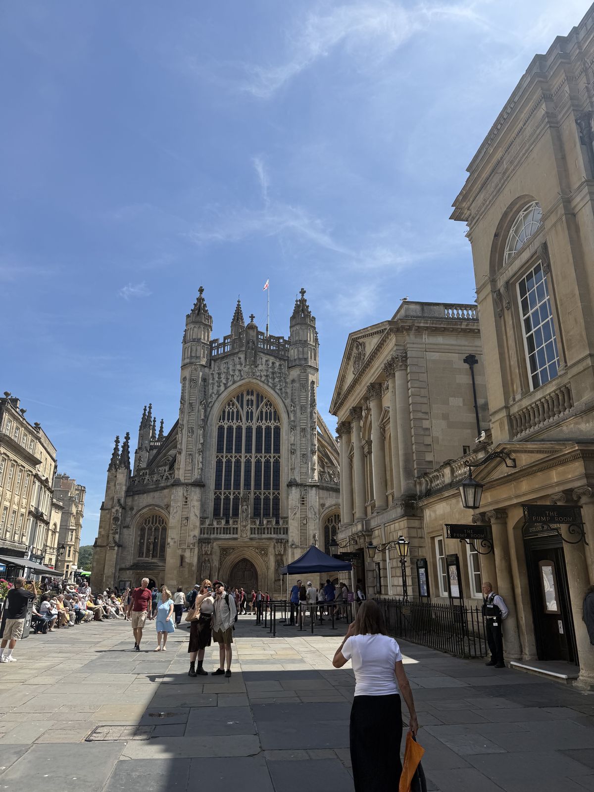 The carved west front of Bath Abbey seen from the courtyard beside the Roman Baths