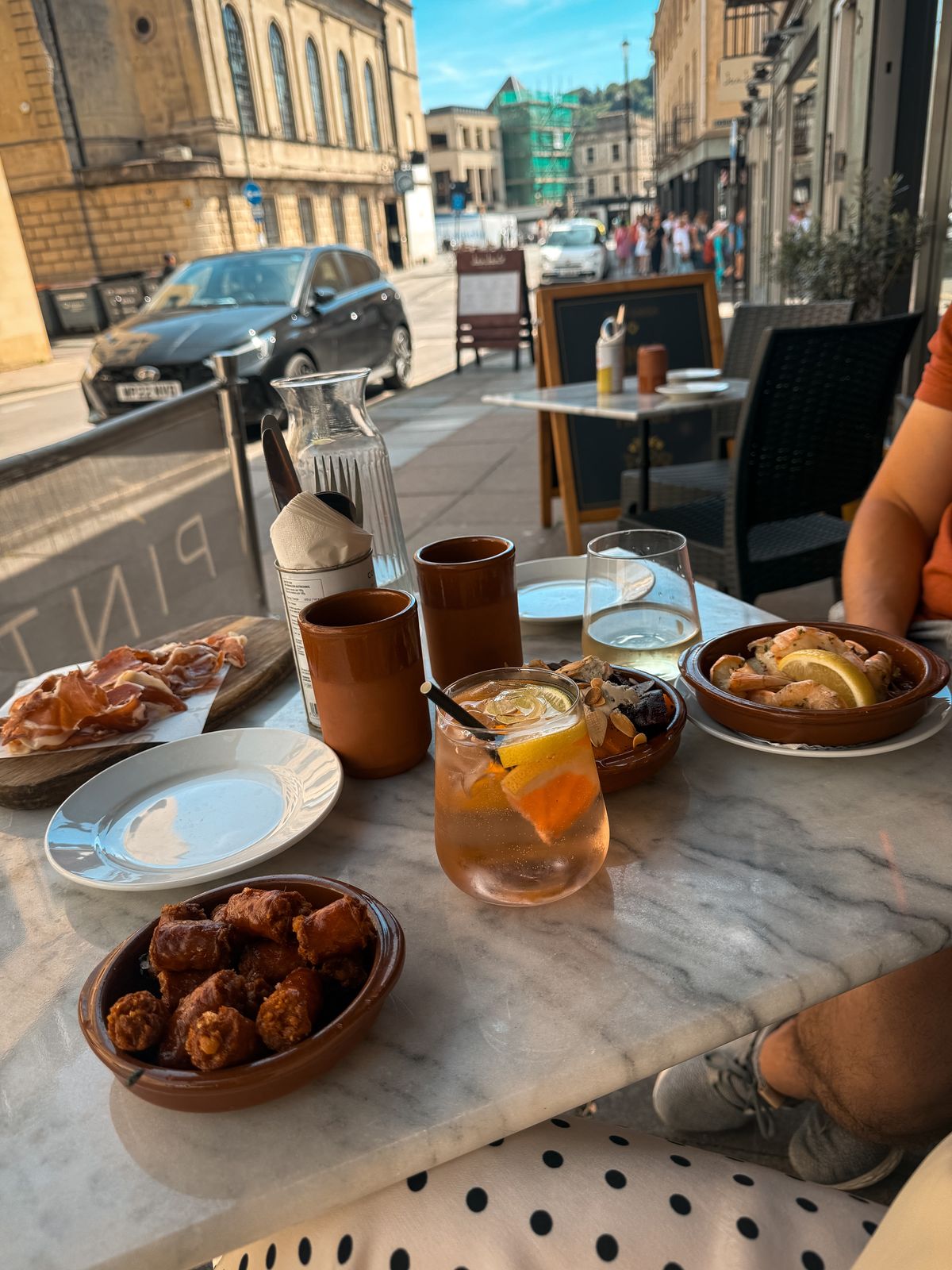 Tapas plates on a pavement cafe table in Bath