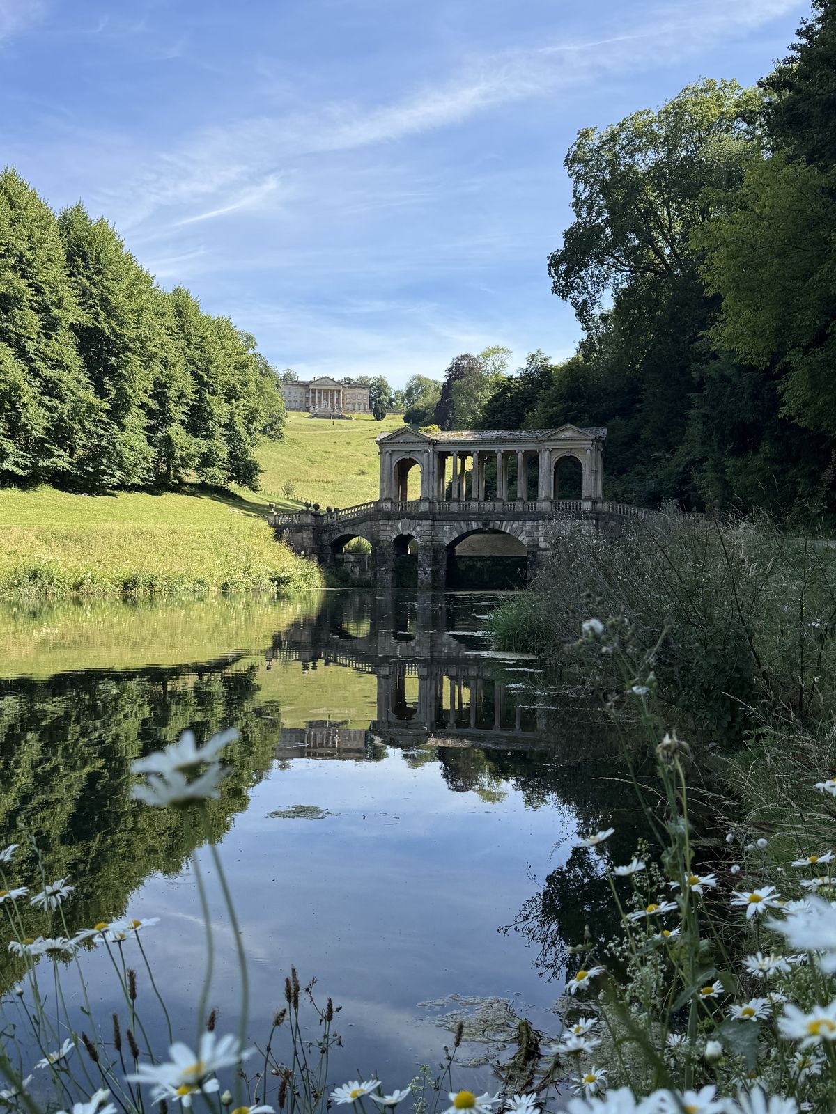 The Palladian Bridge at Prior Park with its reflection in the still water of the lake