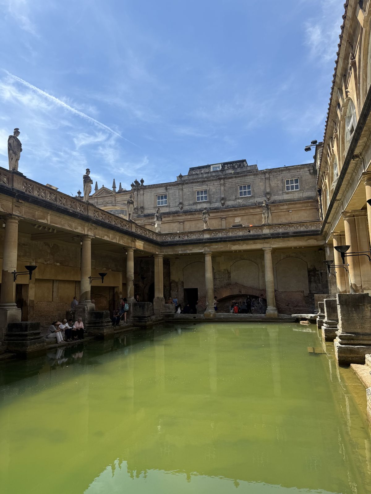 Stone statues lining the terrace above the Great Bath at the Roman Baths in Bath