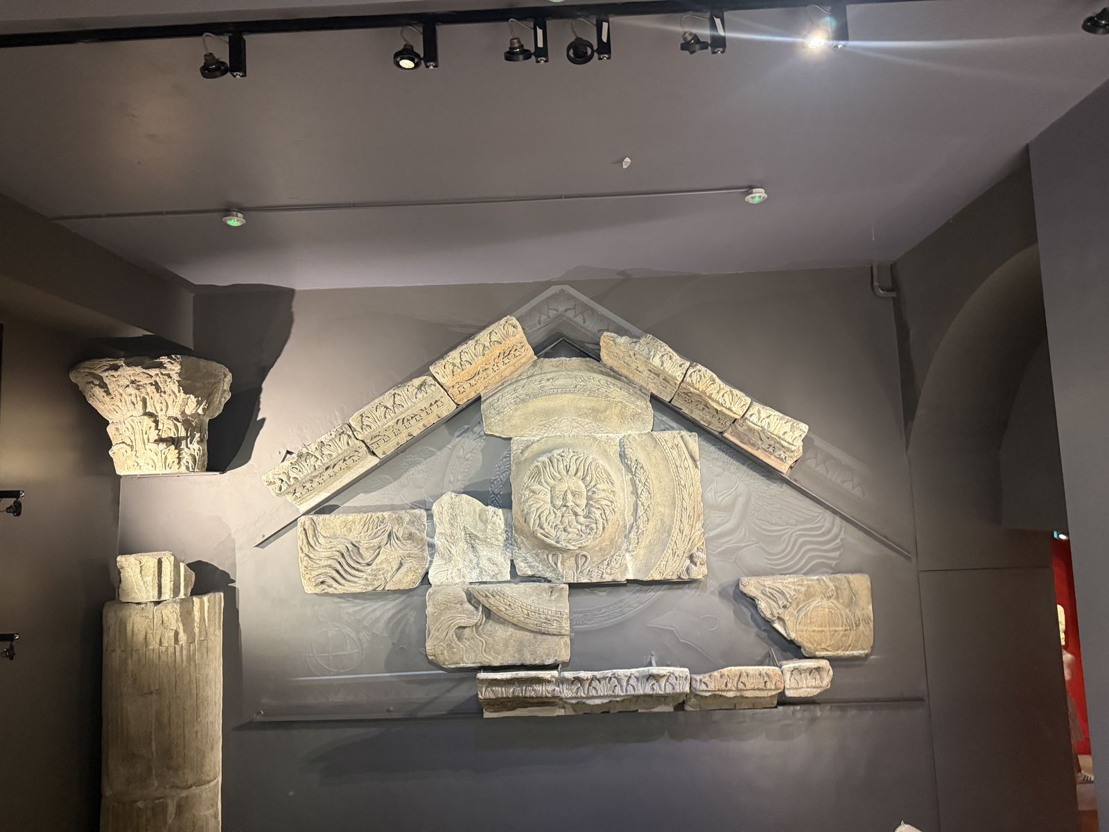 Reconstructed Temple pediment at the Roman Baths museum with the carved Gorgon's head